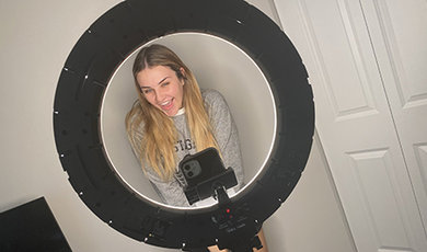 Samantha McGraw records a social media video in front of a ring light in her home.
